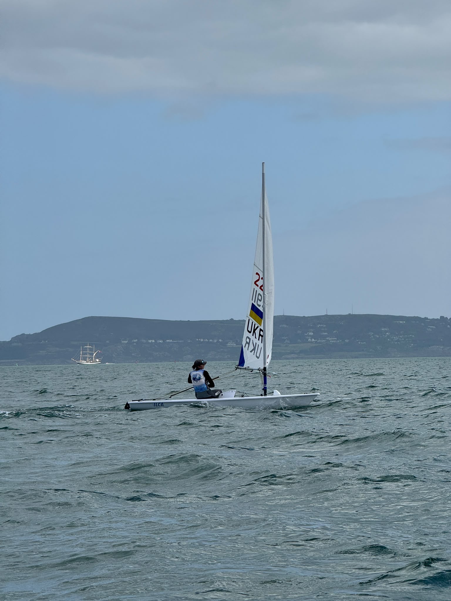 Alina sailing on Dublin Bay with the coastline behind her